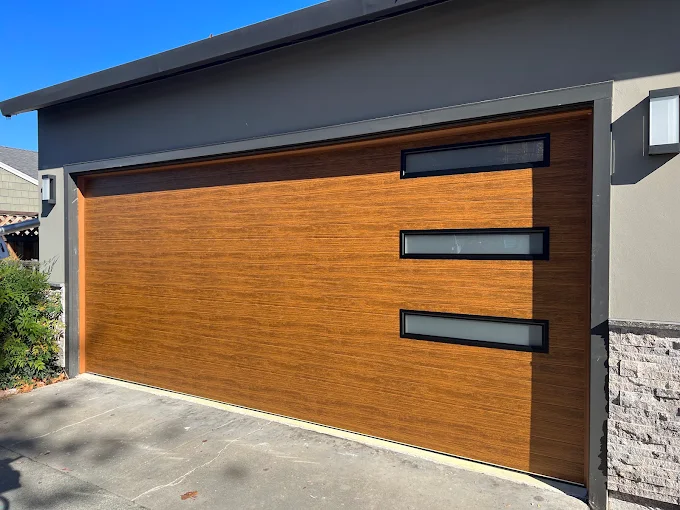 Wood-tone modern garage door with angled window row